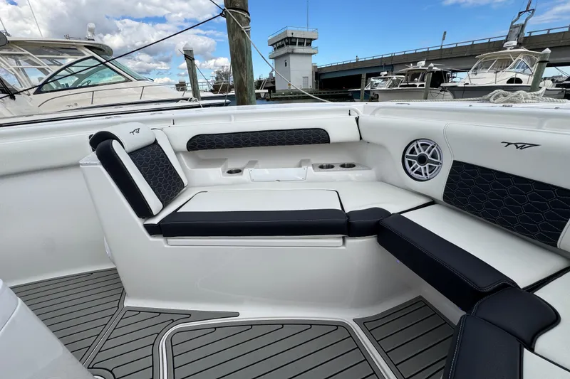 Slide: The Image of 2025 Tidewater 302 CC Adventure boat interior with cushioned seating and speaker system. - 80