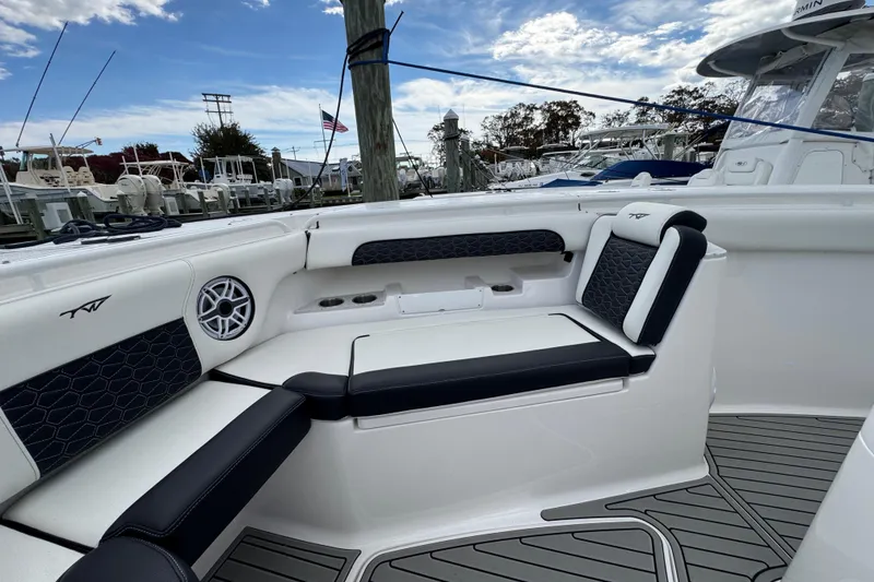 Slide: The Image of 2025 Tidewater 302 CC Adventure boat interior with cushioned seating and speaker. - 81