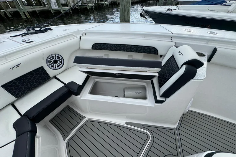 Slide: The Image of 2025 Tidewater 302 CC Adventure boat interior with seating and storage compartments. - 82