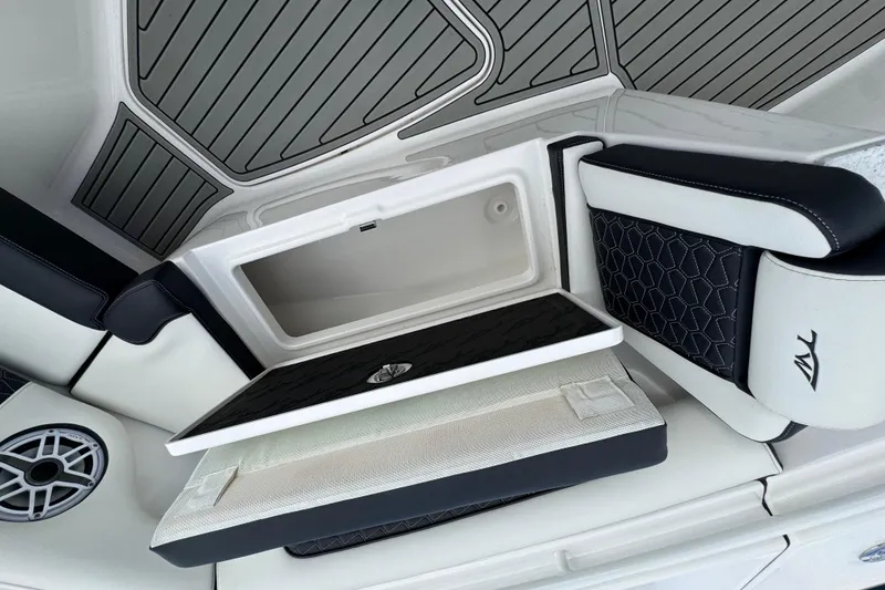 Slide: The Image of 2025 Tidewater 302 CC Adventure boat interior with storage compartment and stylish seating. - 83
