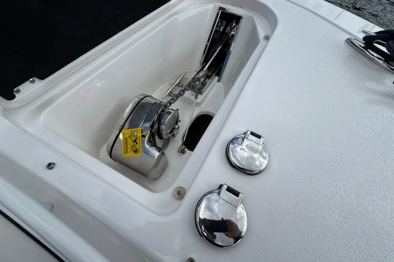 Slide: The Image of 2025 Tidewater 302 CC Adventure boat anchor compartment with chrome fittings. - 87