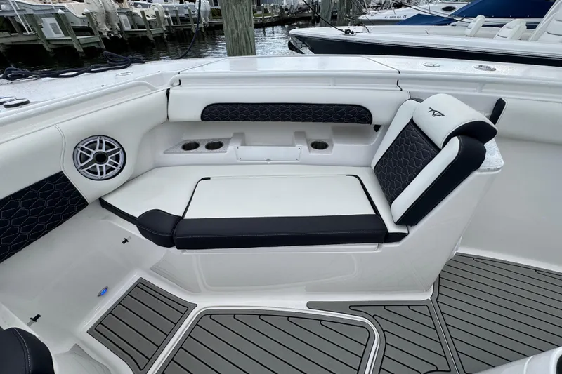Slide: The Image of 2025 Tidewater 302 CC Adventure boat interior with cushioned seating and speaker system. - 88