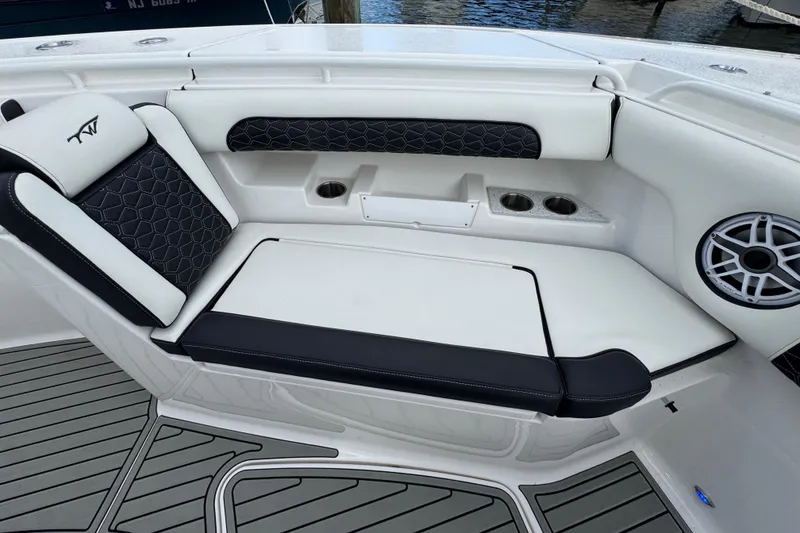 Slide: The Image of 2025 Tidewater 302 CC Adventure boat seating with cup holders and speaker. - 89