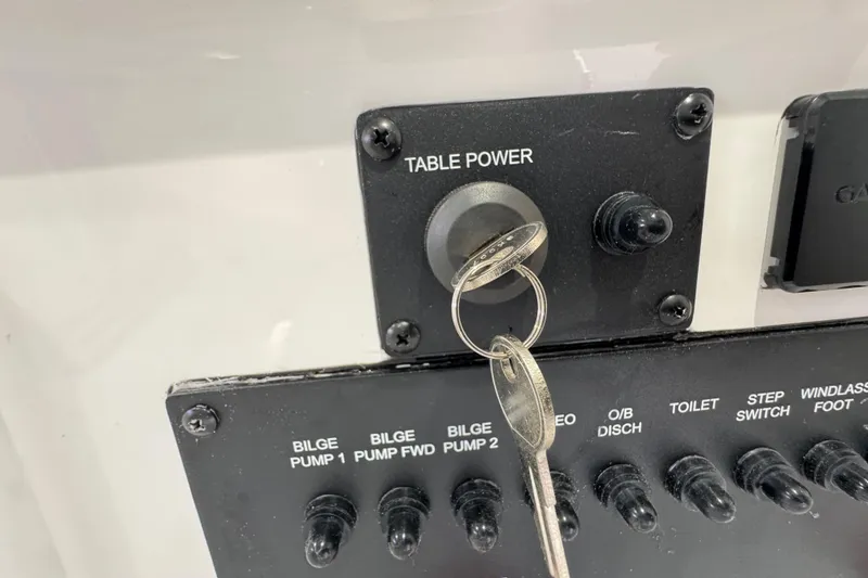 Slide: The Image of Control panel of 2025 Tidewater 302 CC Adventure boat with key in ignition. - 91