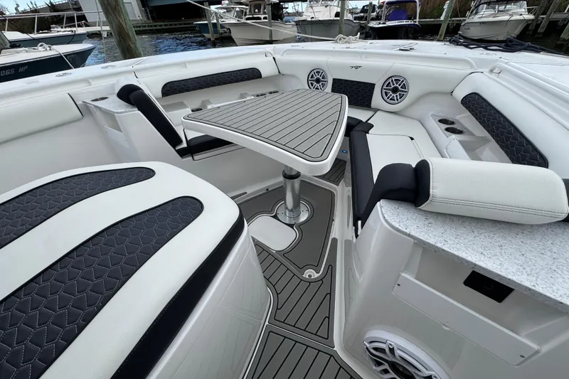 Slide: The Image of 2025 Tidewater 302 CC Adventure boat interior with stylish seating and modern table design. - 92