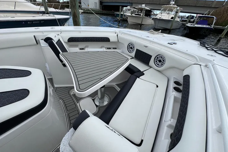 Slide: The Image of Luxurious seating area on 2025 Tidewater 302 CC Adventure boat, featuring stylish upholstery and speakers. - 94