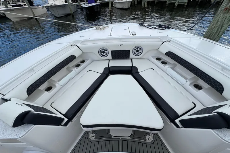 Slide: The Image of 2025 Tidewater 302 CC Adventure boat interior with cushioned seating and cup holders. - 99