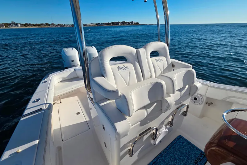 Slide: The Image of 2022 Mag Bay 33 CC boat interior with white seating on open water. - 11