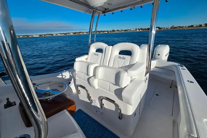 Slide: The Image of 2022 Mag Bay 33 CC boat interior with white seating on open water. - 12