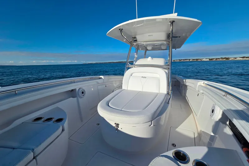 Slide: The Image of 2022 Mag Bay 33 CC boat on open water, featuring sleek design and spacious deck. - 13