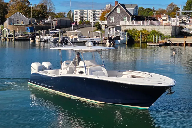 Slide: The Image of 2022 Mag Bay 33 CC boat docked in a scenic marina setting. - 17