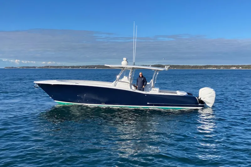 Slide: The Image of 2022 Mag Bay 33 CC boat on calm ocean waters under clear blue sky. - 3