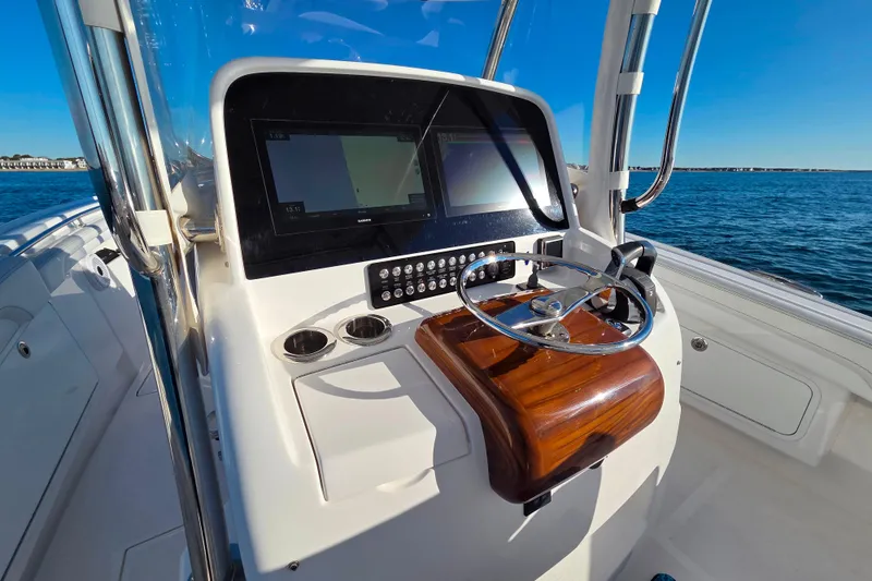 Slide: The Image of 2022 Mag Bay 33 CC boat helm with modern controls and ocean view. - 8