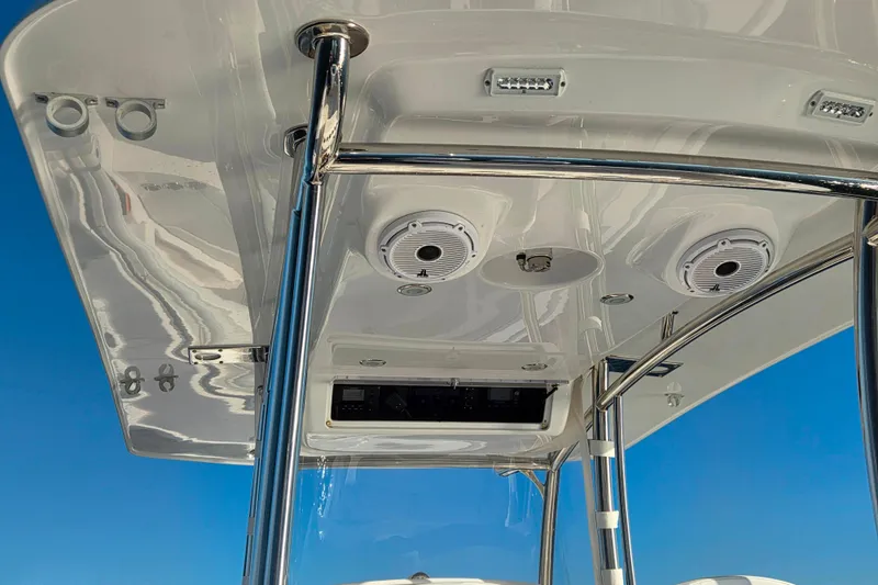 Slide: The Image of 2022 Mag Bay 33 CC boat's T-top with speakers and lights against blue sky. - 9