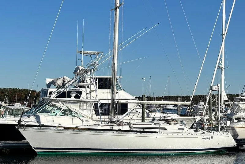 The Image of 1986 Beneteau First 42 sailboat docked at marina under clear blue sky. - 1