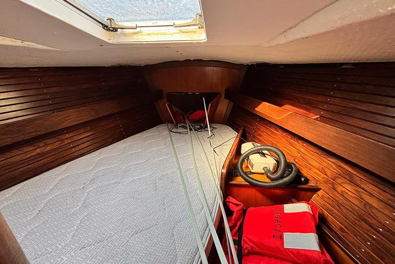 Slide: The Image of Cozy cabin interior of 1986 Beneteau First 42 sailboat with wooden paneling and skylight. - 13