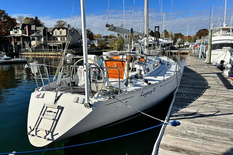 Slide: The Image of 1986 Beneteau First 42 sailboat docked at a marina, sunny day, waterfront homes. - 3