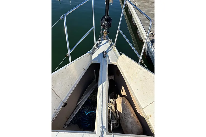 Slide: The Image of Bow of 1986 Beneteau First 42 sailboat with open storage compartments. - 7