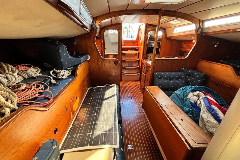 Slide: The Image of Interior of a 1986 Beneteau First 42 sailboat with wooden furnishings and nautical decor. - 8