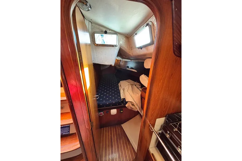 Slide: The Image of Cozy cabin interior of 1986 Beneteau First 42 sailboat with wooden finish and porthole. - 9