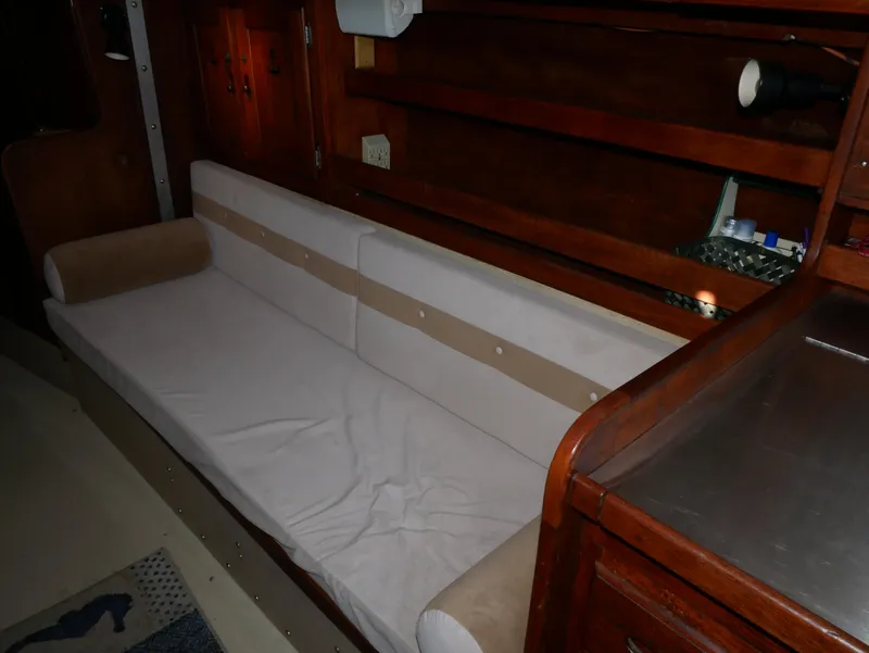 Slide: The Image of Interior of 1982 Catalina 38 sailboat with beige seating and wooden cabinetry. - 21