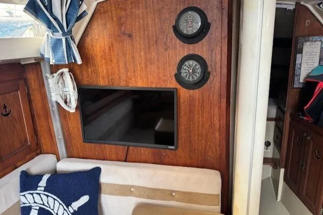 Slide: The Image of Interior of 1982 Catalina 38 sailboat with wood paneling, TV, and nautical decor. - 22