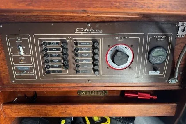 Slide: The Image of Control panel of a 1982 Catalina 38 sailboat with AC/DC switches and battery selector. - 26