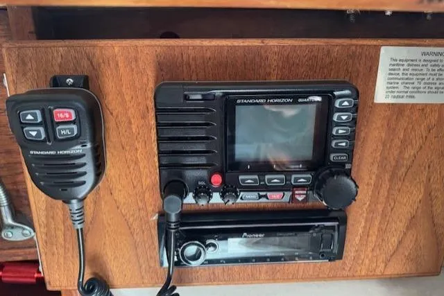Slide: The Image of Control panel of a 1982 Catalina 38 sailboat featuring a Standard Horizon radio and Pioneer stereo. - 28