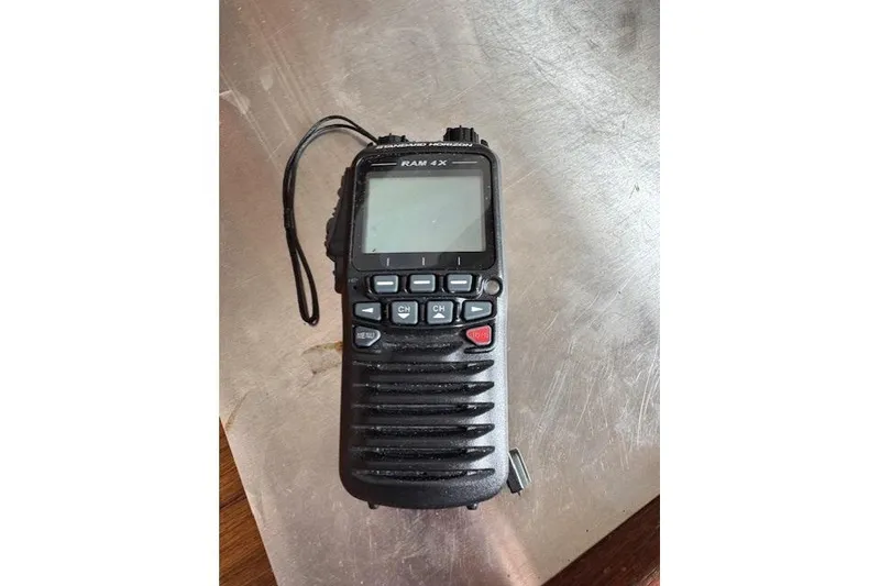 Slide: The Image of Handheld radio device on a metallic surface, featuring a screen and multiple buttons. - 29