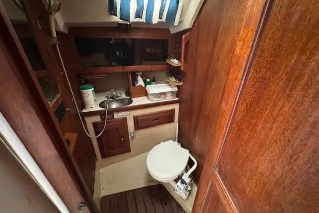 Slide: The Image of 1982 Catalina 38 sailboat bathroom with wooden cabinetry and compact design. - 30