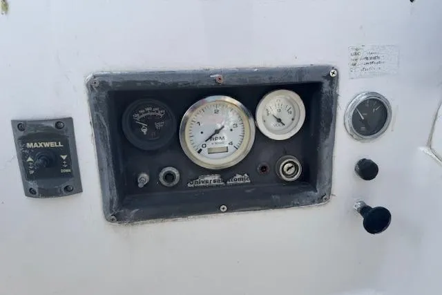 Slide: The Image of Control panel of a 1982 Catalina 38 sailboat with gauges and switches. - 33