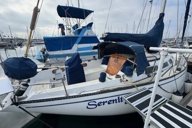 Slide: The Image of 1982 Catalina 38 sailboat named "Serenity" docked in a marina. - 4