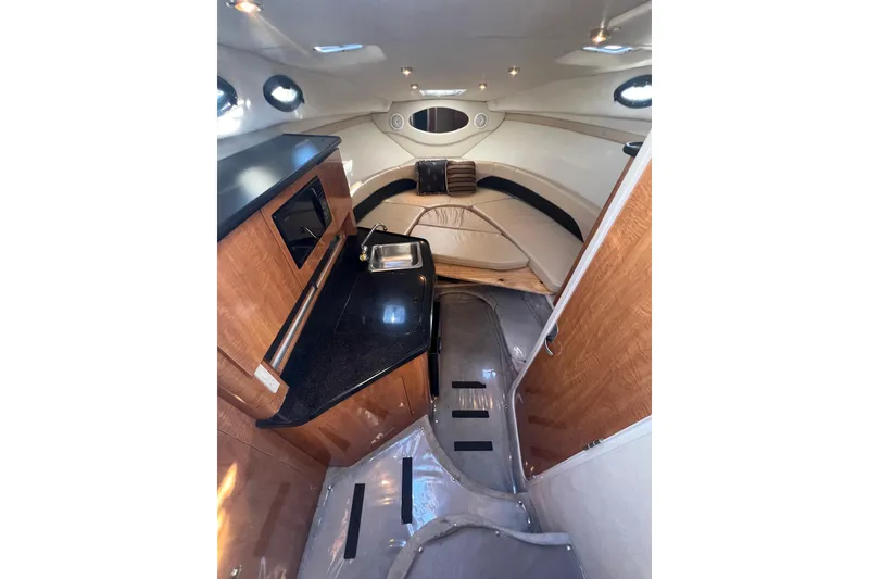 Slide: The Image of 2002 Regal Commodore 2765 cabin interior with kitchenette and seating area. - 11