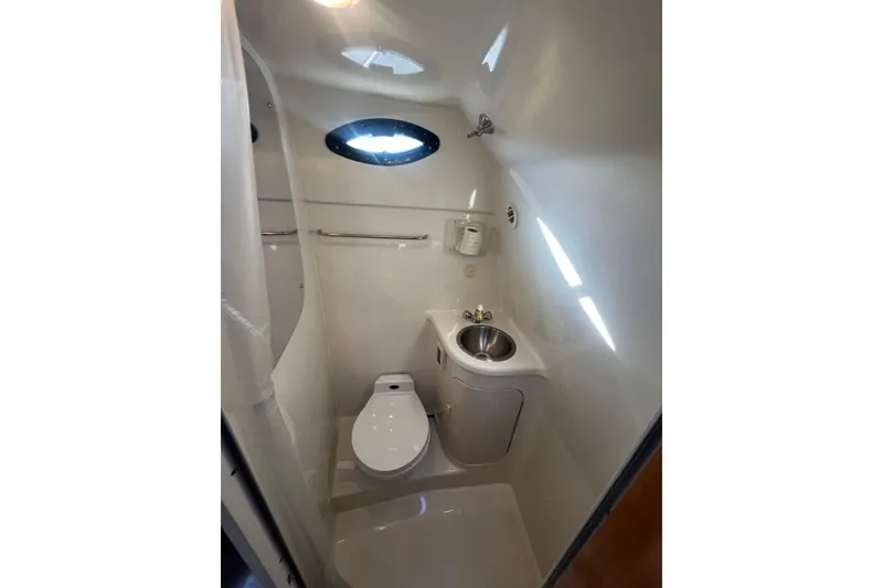 Slide: The Image of Compact bathroom in 2002 Regal Commodore 2765 boat with toilet and sink. - 16