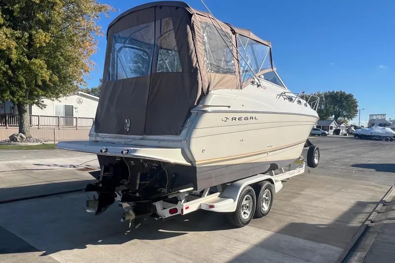 Slide: The Image of 2002 Regal Commodore 2765 boat on trailer, covered, parked outdoors. - 3