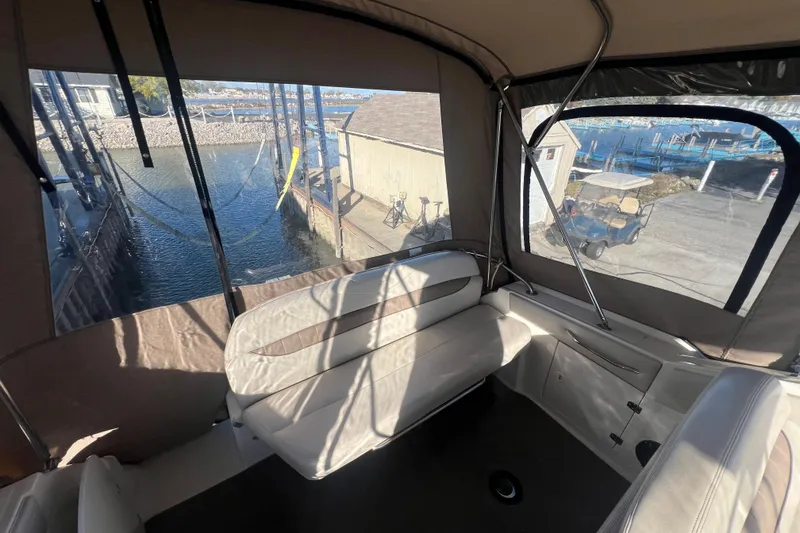 Slide: The Image of Interior view of 2002 Regal Commodore 2765 boat with marina backdrop. - 7