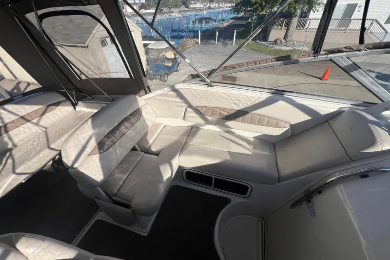 Slide: The Image of Interior of a 2002 Regal Commodore 2765 boat with beige seating and waterfront view. - 9
