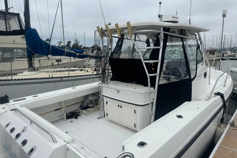 The Image of 2001 Boston Whaler 28 Outrage cruising near rocky island with lighthouse. - 0