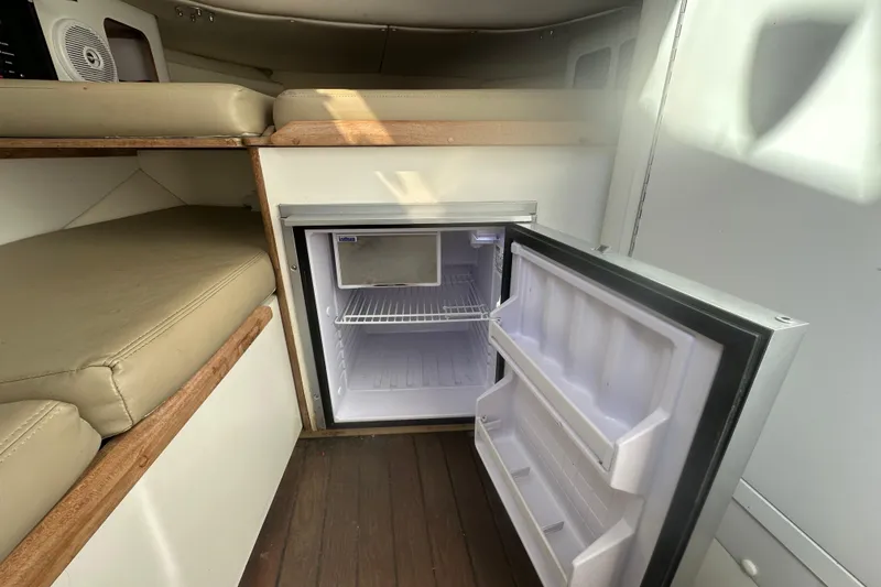 Slide: The Image of Interior cabin of a 2001 Boston Whaler 28 Outrage boat, featuring a compact restroom. - 23