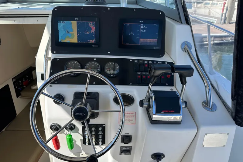 Slide: The Image of 2001 Boston Whaler 28 Outrage boat interior with fishing gear and console. - 8
