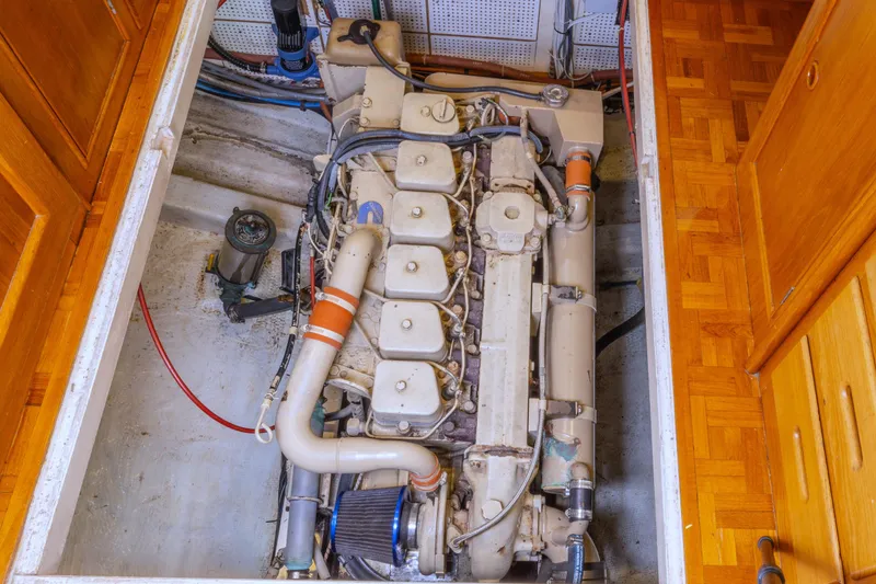 Slide: The Image of Engine compartment of a 1987 Grand Banks 32 Sedan boat, showcasing detailed machinery. - 23