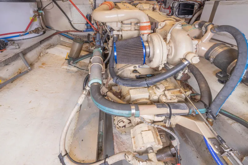 Slide: The Image of Engine room of 1987 Grand Banks 32 Sedan with visible hoses and components. - 24