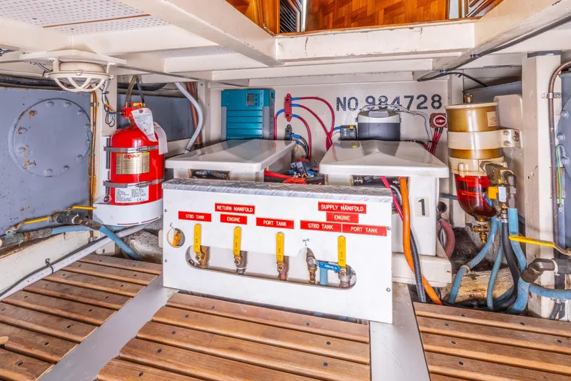 Slide: The Image of Engine room of 1987 Grand Banks 32 Sedan with fire extinguisher and fuel manifold system. - 25