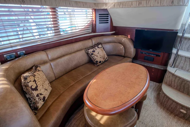 Slide: The Image of Luxurious interior of 2006 Sea Ray 40 Motor Yacht with seating, table, and entertainment area. - 14