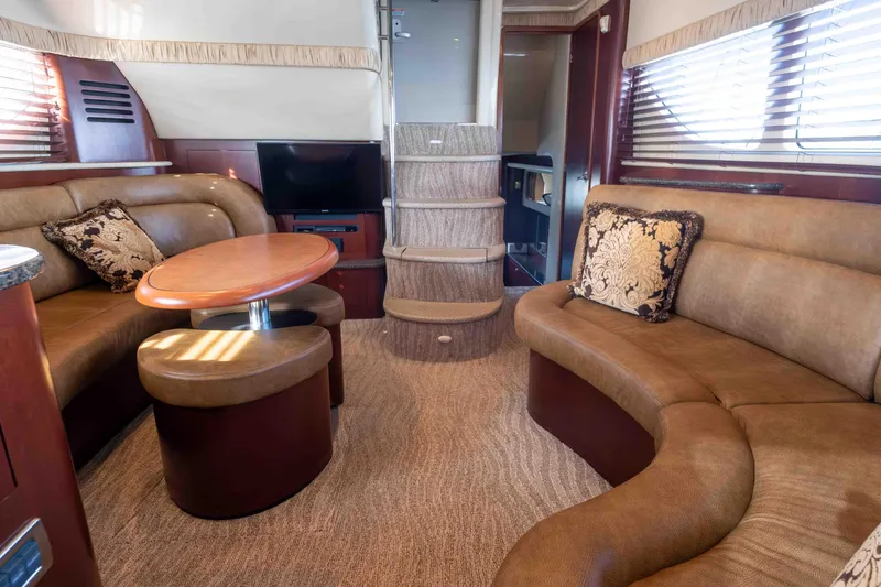 Slide: The Image of 2006 Sea Ray 40 Motor Yacht helm with navigation screens and controls, overlooking waterfront. - 15