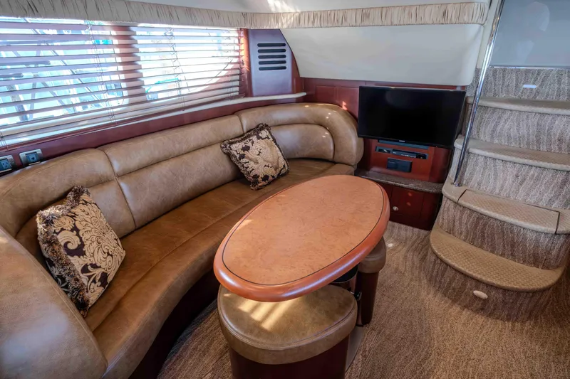 Slide: The Image of 2006 Sea Ray 40 Motor Yacht helm with dual screens and wooden steering wheel. - 16