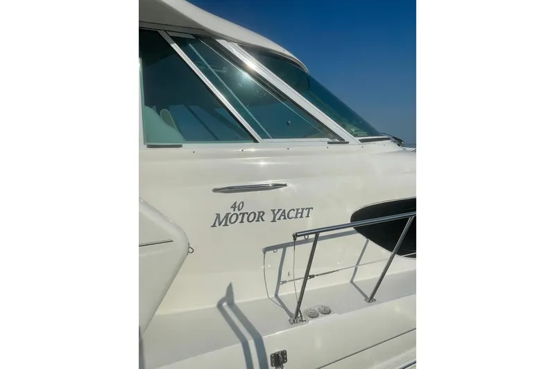 Slide: The Image of 2006 Sea Ray 40 Motor Yacht docked in a serene marina setting. - 2