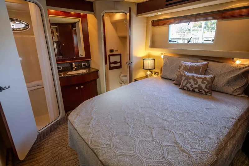Slide: The Image of Luxurious 2006 Sea Ray 40 Motor Yacht bedroom with ensuite bathroom and elegant decor. - 34