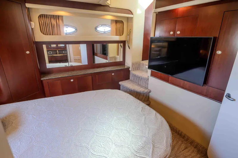 Slide: The Image of Luxurious 2006 Sea Ray 40 Motor Yacht bedroom with TV and elegant wood finishes. - 35