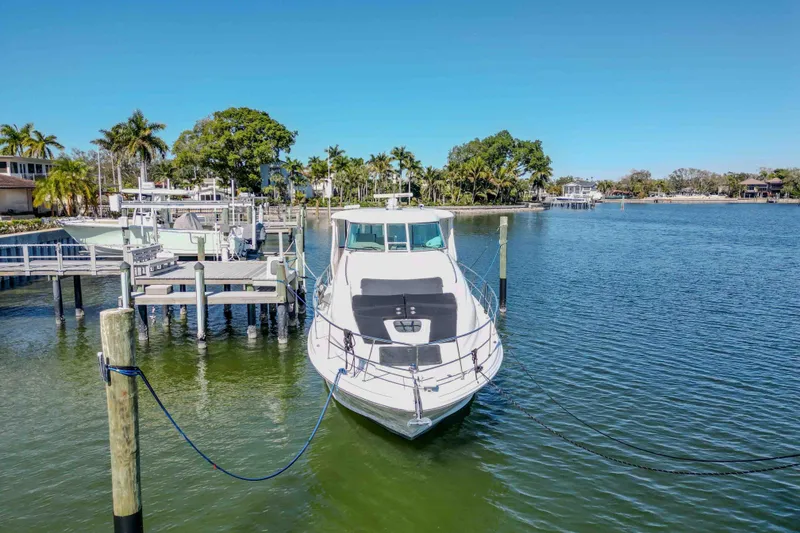 Slide: The Image of 2006 Sea Ray 40 Motor Yacht docked in a scenic marina setting. - 37